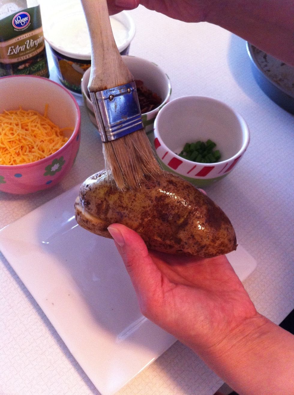 Brush the potato with olive oil