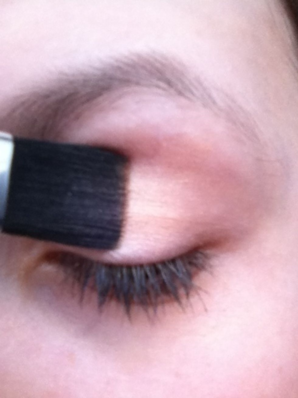 Brush the whole of your eyelid with the brown eyeshadow and a thick brush.