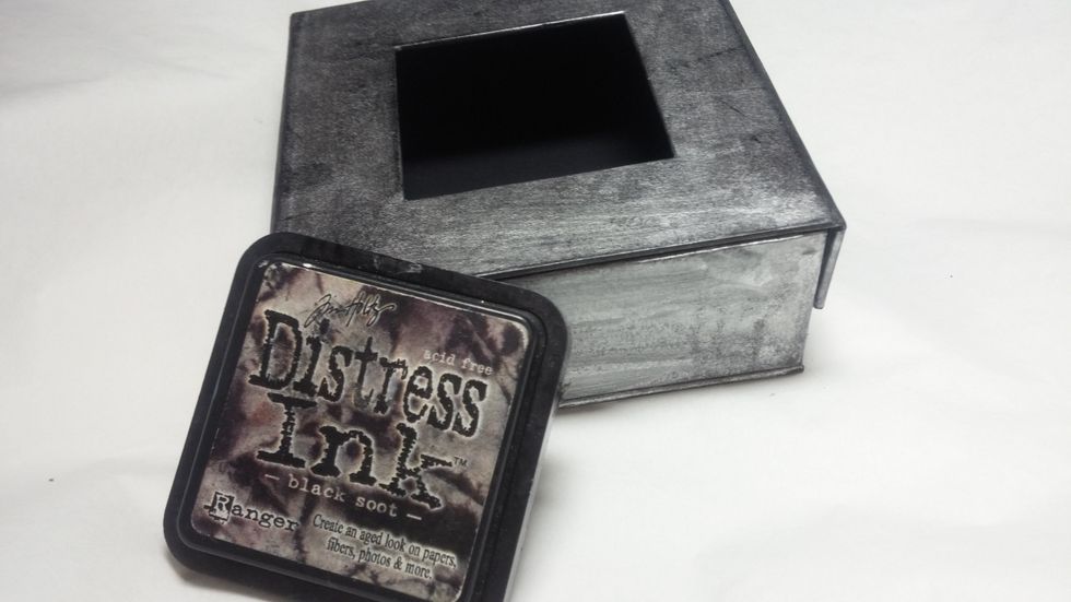 Buff on a bit of black distress ink. Then start to spritz the base with water to get great effects.