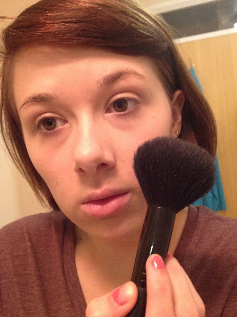 Buff on your translucent powder with a big fluffy brush