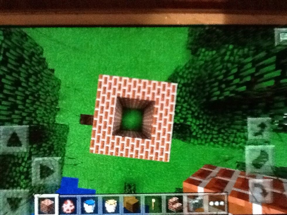 Build a 3 block high 4 by 4 space with the bricks by touching the ground with your finger