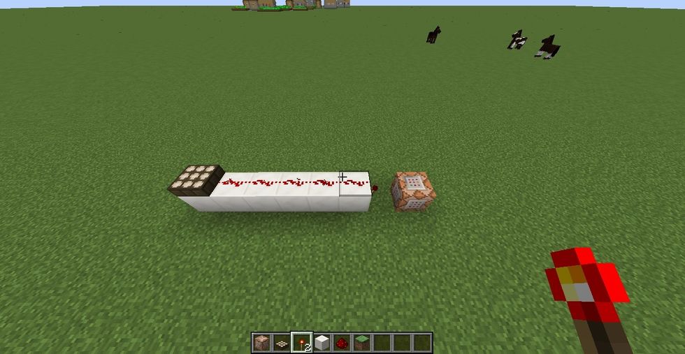 Build a redstone contraption like this. What this does is that when it is daytime, the daylight sensor sends out a signal that turns off the redstone torch. When it is night, the command is activated.