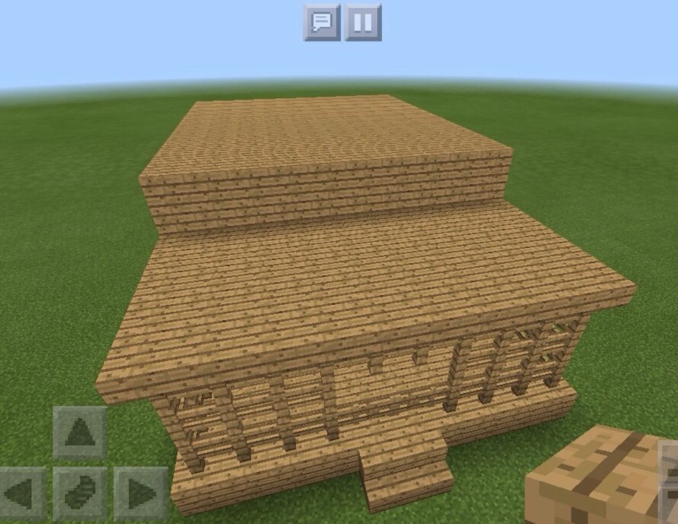 Build the house up another block, this time adding on the roof.