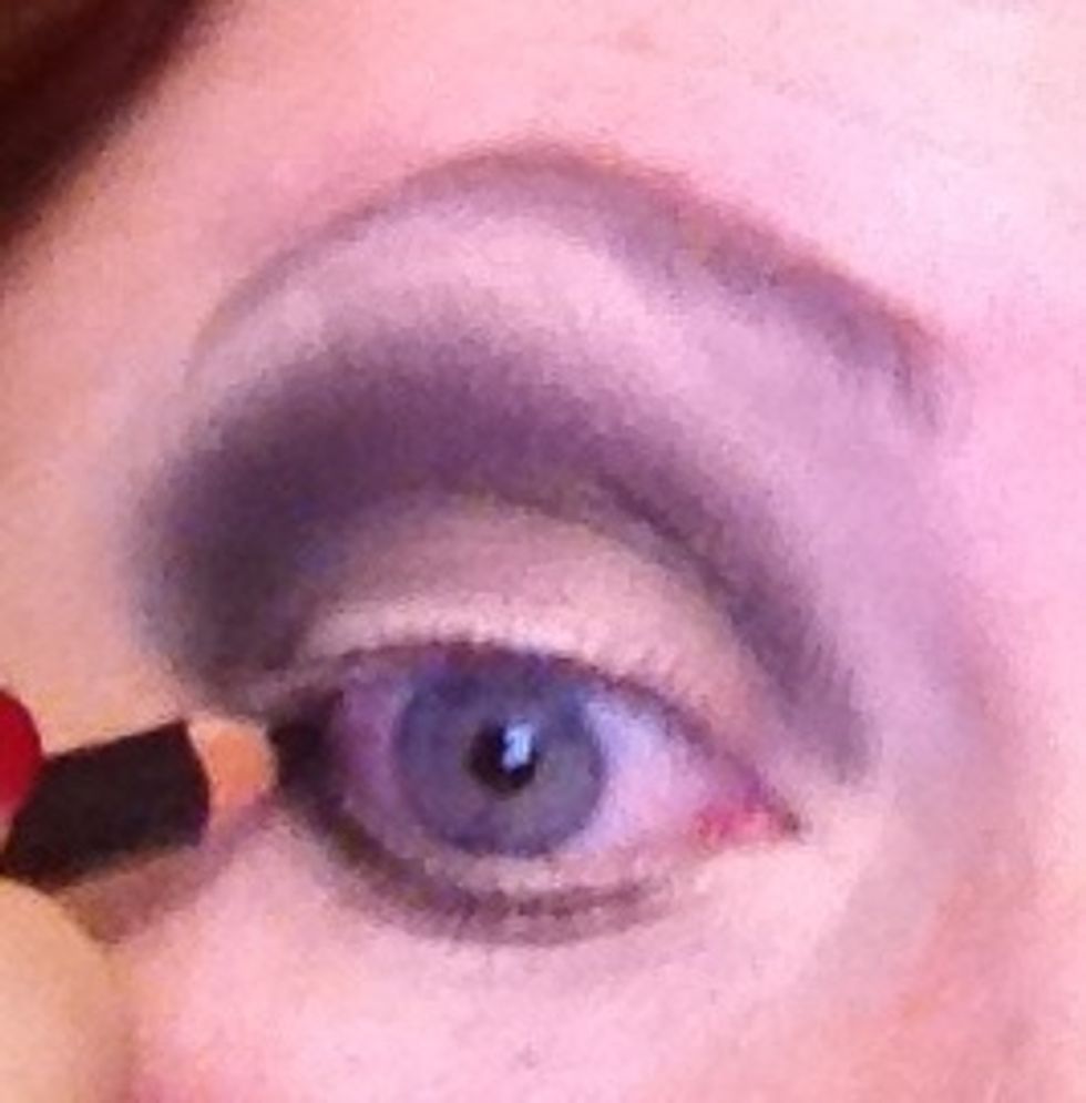 building of colour now adding a bit of dark brown into the black to make it less harsh.  Take a kohl pencil I'm using illamasqua Sophie pencil on my waterline I'm only going half way into the line