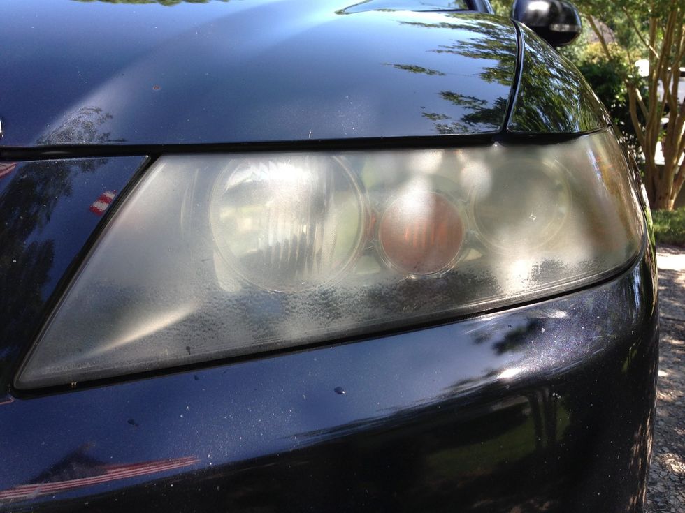 Built up grime and oxidation 'fogs' up the headlights.