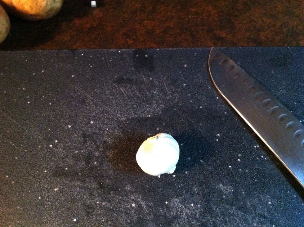 Bulb of Garlic, knife and cutting board.