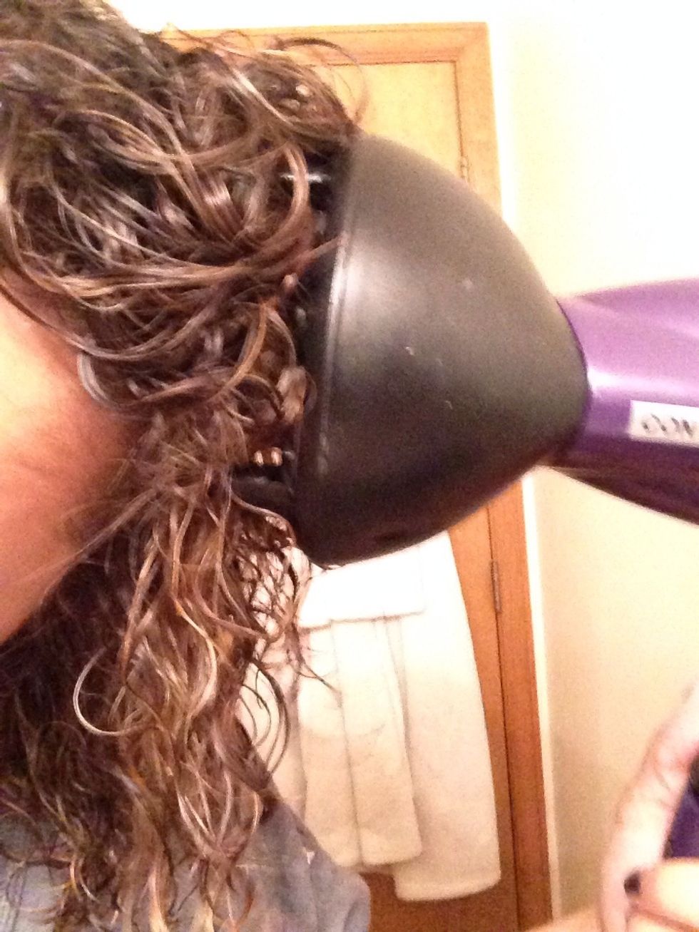 Bunch your hair from the bottom and then put to diffuser against your head. The long bristles won't burn you.