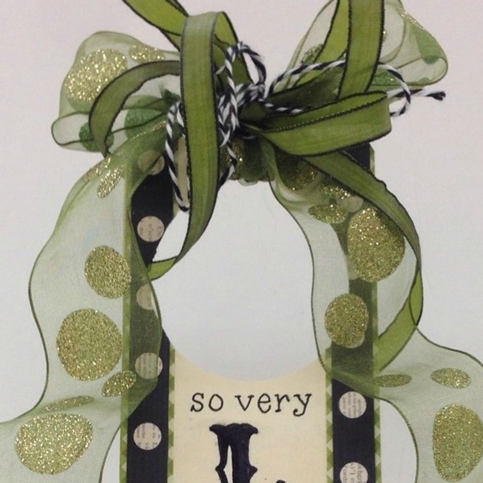 Bundle the ribbons and twine together and tie a bow at the top of the hanger.