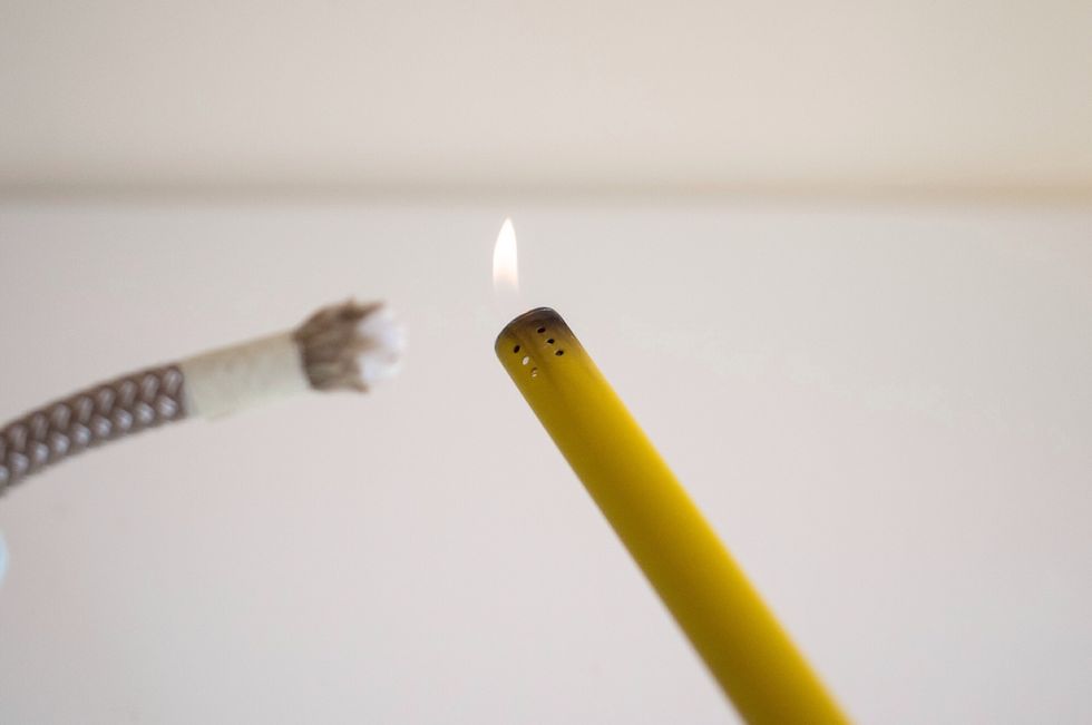 Burn the end of the rope, so that it melts together. You might want to try it before on a small piece, and not too far from the sink, just in case ))