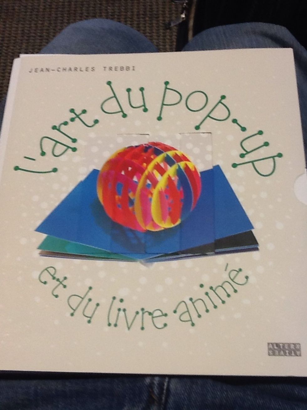 But one might guess from the name of the book the following: The folded single cube is glued to the center of the card which can be folded flat? Perhaps . . .
