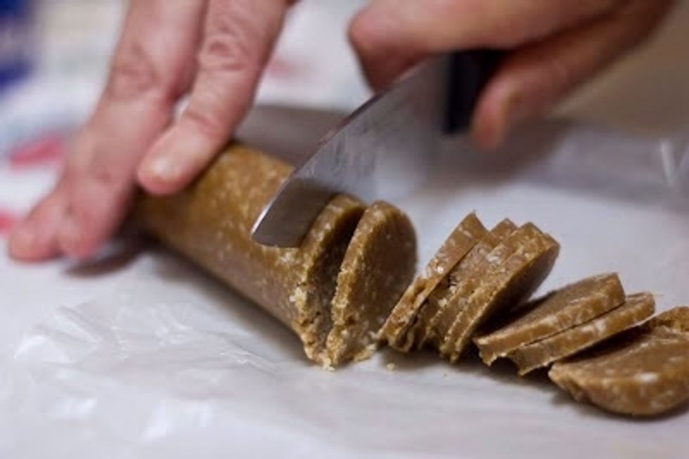 But say you'd like to have these cookies right now. Preheat the oven to 350 degrees. Wait 30 minutes ,line a cookie sheet with parchment paper. Slice off the number of cookies you'd like to bake.