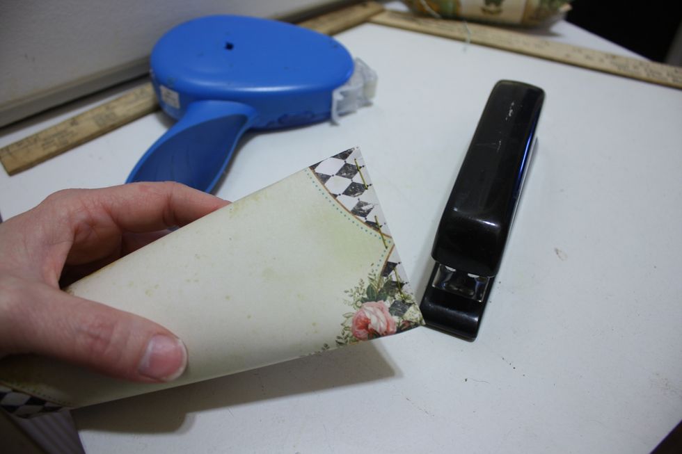 but this time when you fold in half, take a stapler and staple the bottom shut
