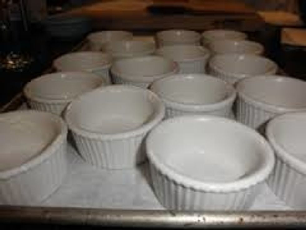 BUTTER 4 small custard cups; place on baking sheet