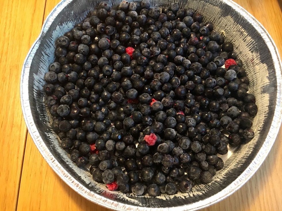 Butter a pie tin. Fill it with (blue)berries- fresh or frozen. A few raspberries found its way to this pie, was out picking blueberries and found some wild raspberries too \ud83d\ude00