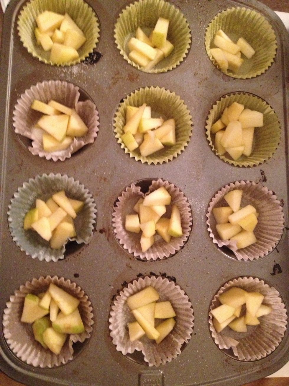 Butter and sugar muffin tins than drop some apples