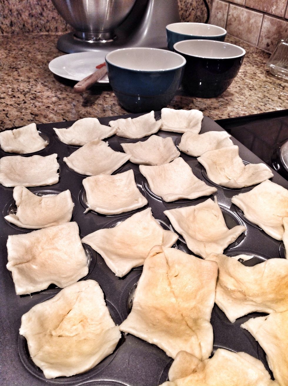 Butter cupcake pan. Open the crescents, flatten them slightly, then cut into squares. Place them in the cups. I made small squares for popper sized treats. Aunt Ruth's large one makes great hand pies!