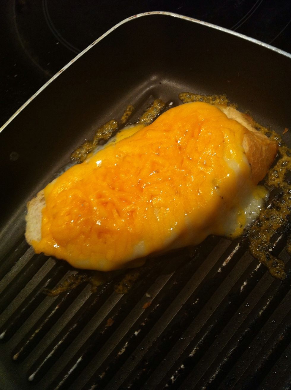Butter on the pan then put ur bread in so bread soak all the butter goodness then top with Swiss cheese and cheddar