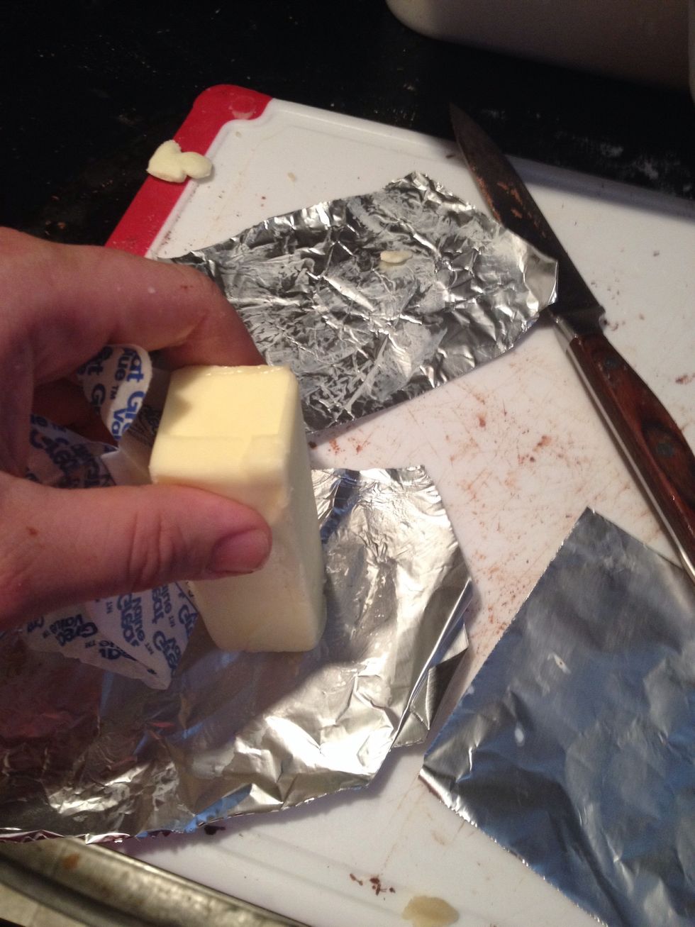 Butter pieces of foil and place over the tart case/s
