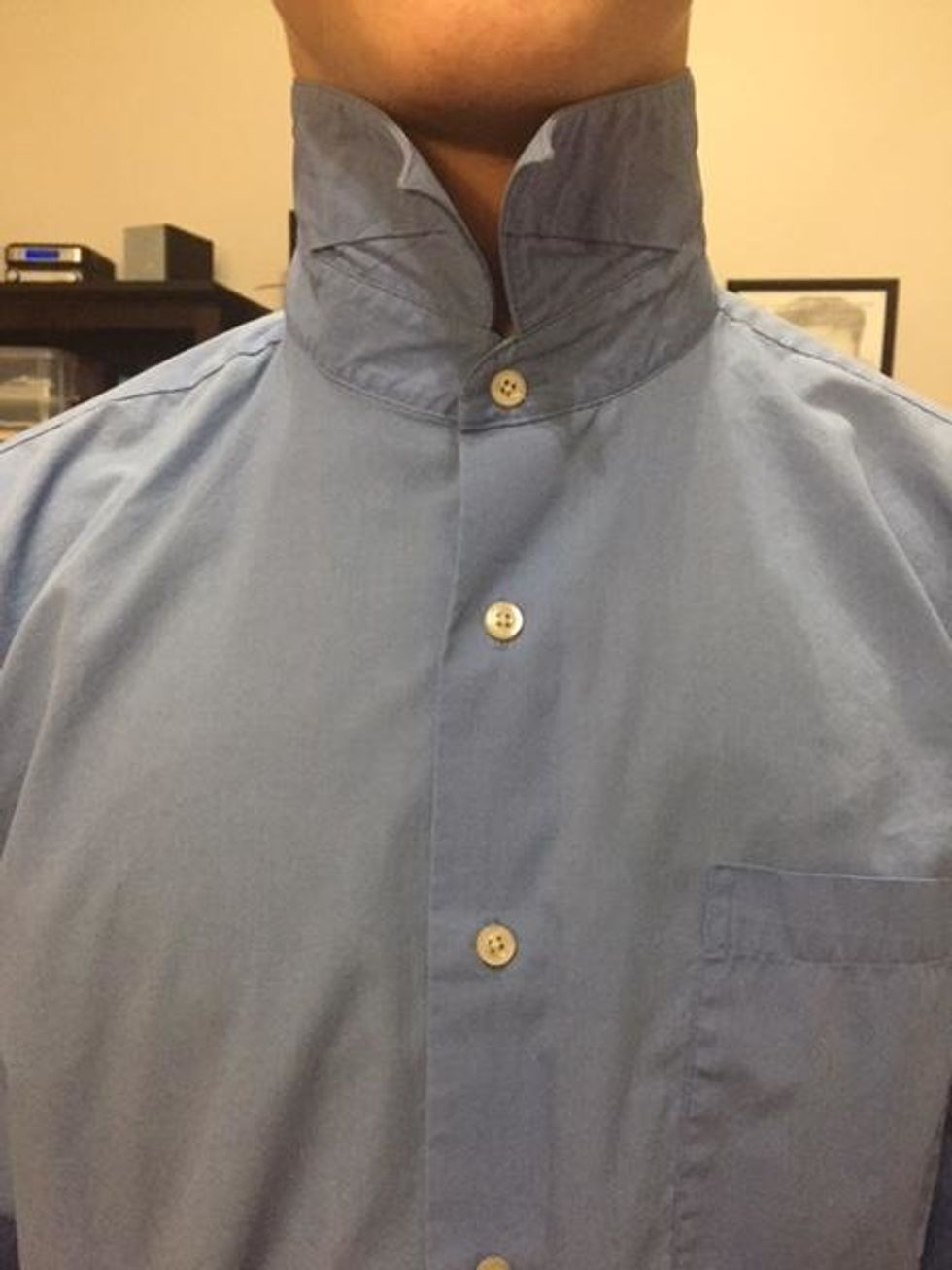 Button up your shirt, and fold the collar up.