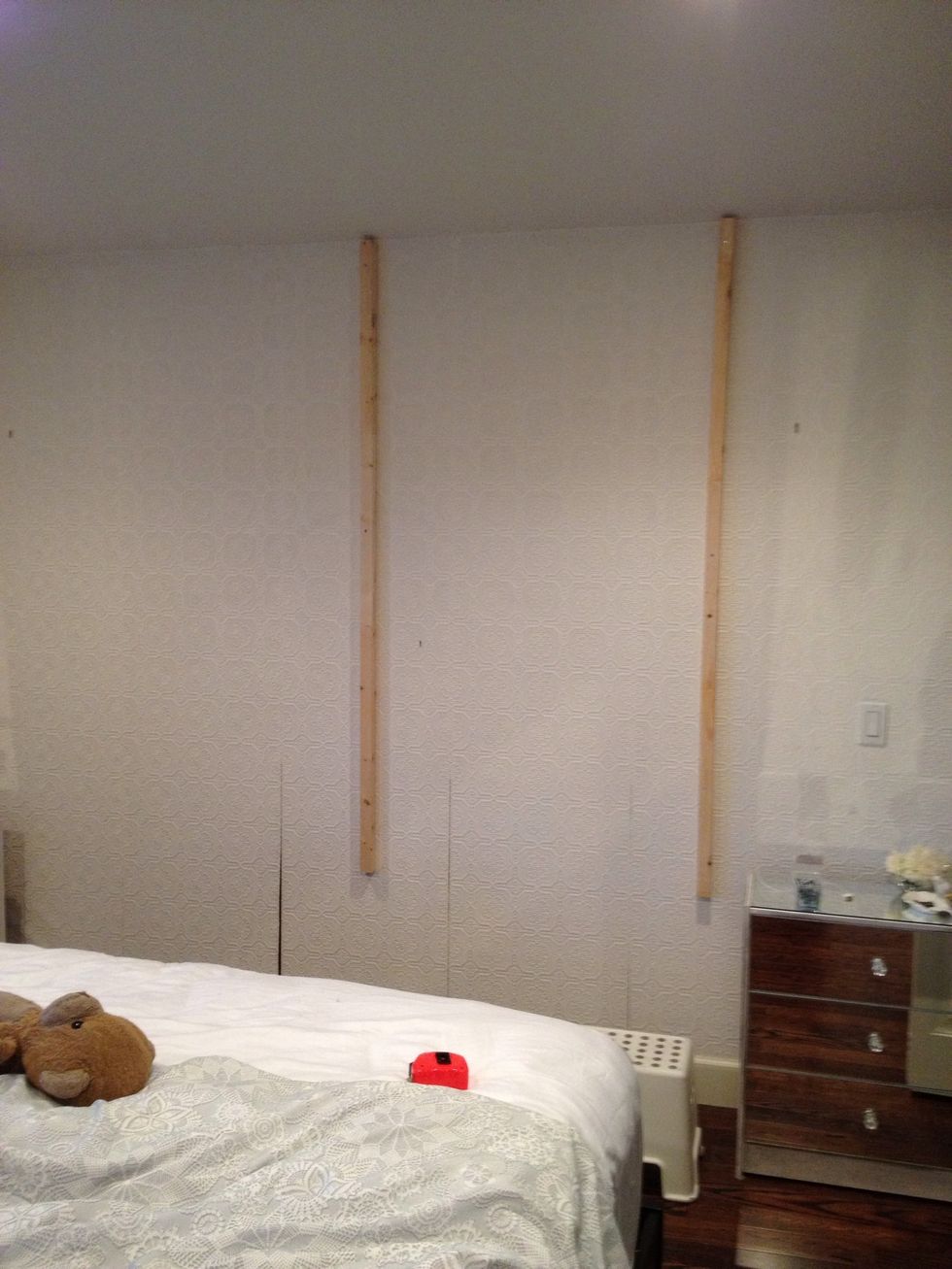 Buy 5 2x2 pine strips and screw into wall, evenly spaced and the width of your king size bed, this is the base for your headboard. We did ours all the way up to the ceiling.