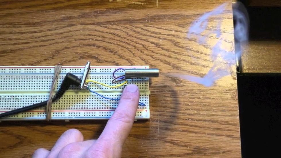 buy a small smoke maker from a store and if they don't have one use anything that will make smoke and put it o n the boat and don't let anyone see the smoke maker place it in the boat and cover it