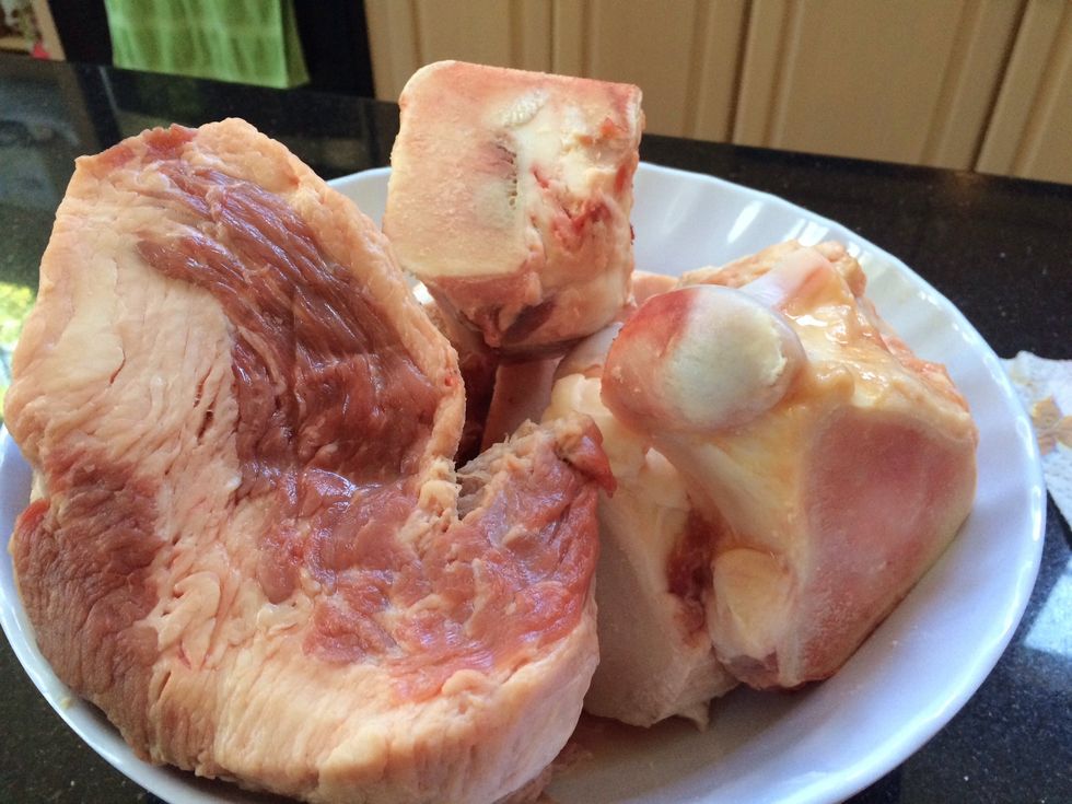 Buy beef bones with white center, and marrow (3lbs), tendons, and fatty cut of brisket. Clean brisket, tendon and bones, (boil and drain).