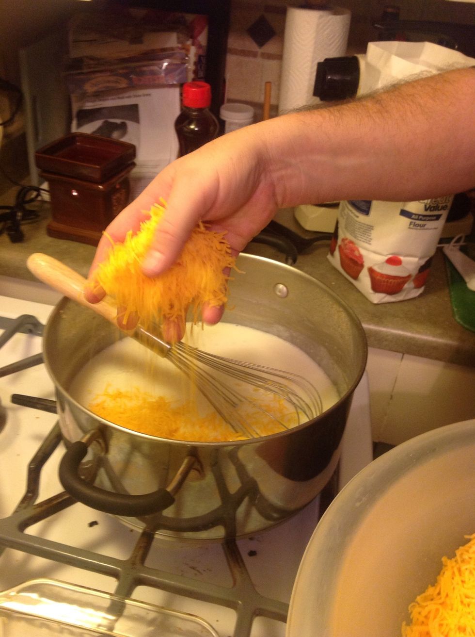 By mixing the cheese in slowly, you will gradually make a thick cheese sauce rather than a milk sauce with cheese.