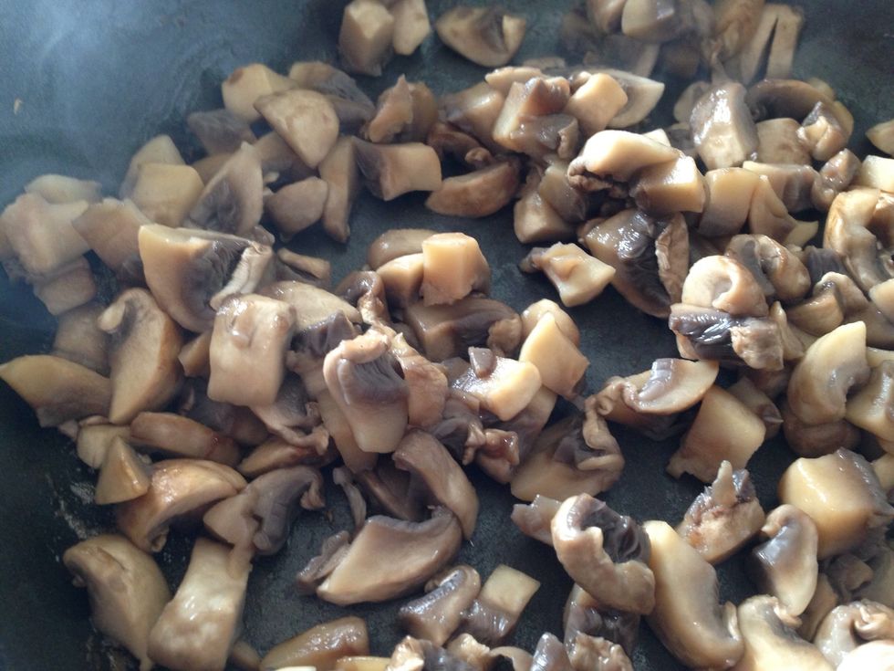 By now, the mushrooms should be done sweating. Add 1 tsp olive oil now, and cook another minute or so until slightly browned on the edges. Transfer to a bowl.