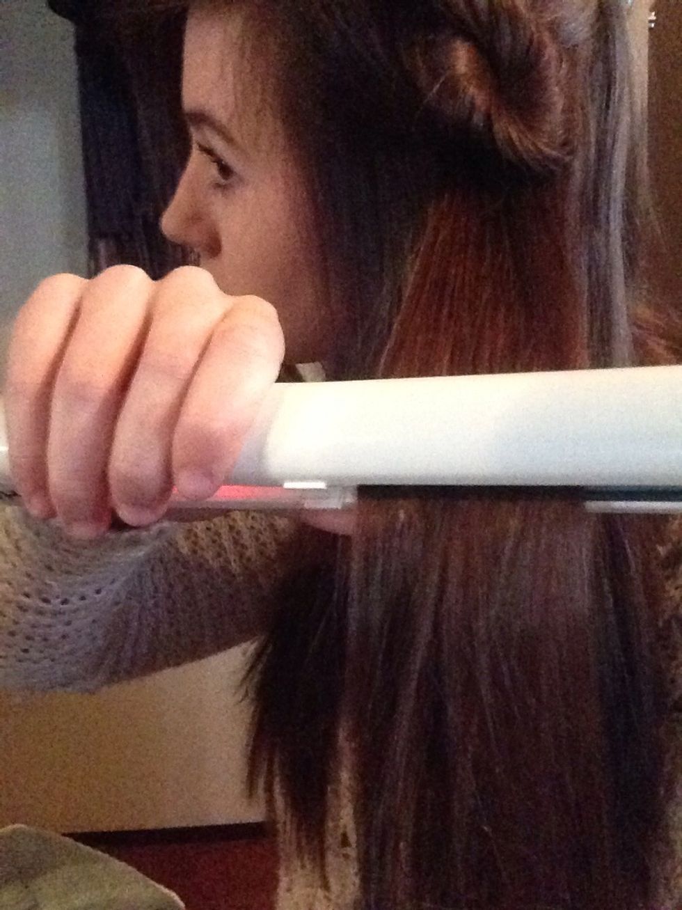 By pulling your hair away from your face and letting it fall down makes it straighter.