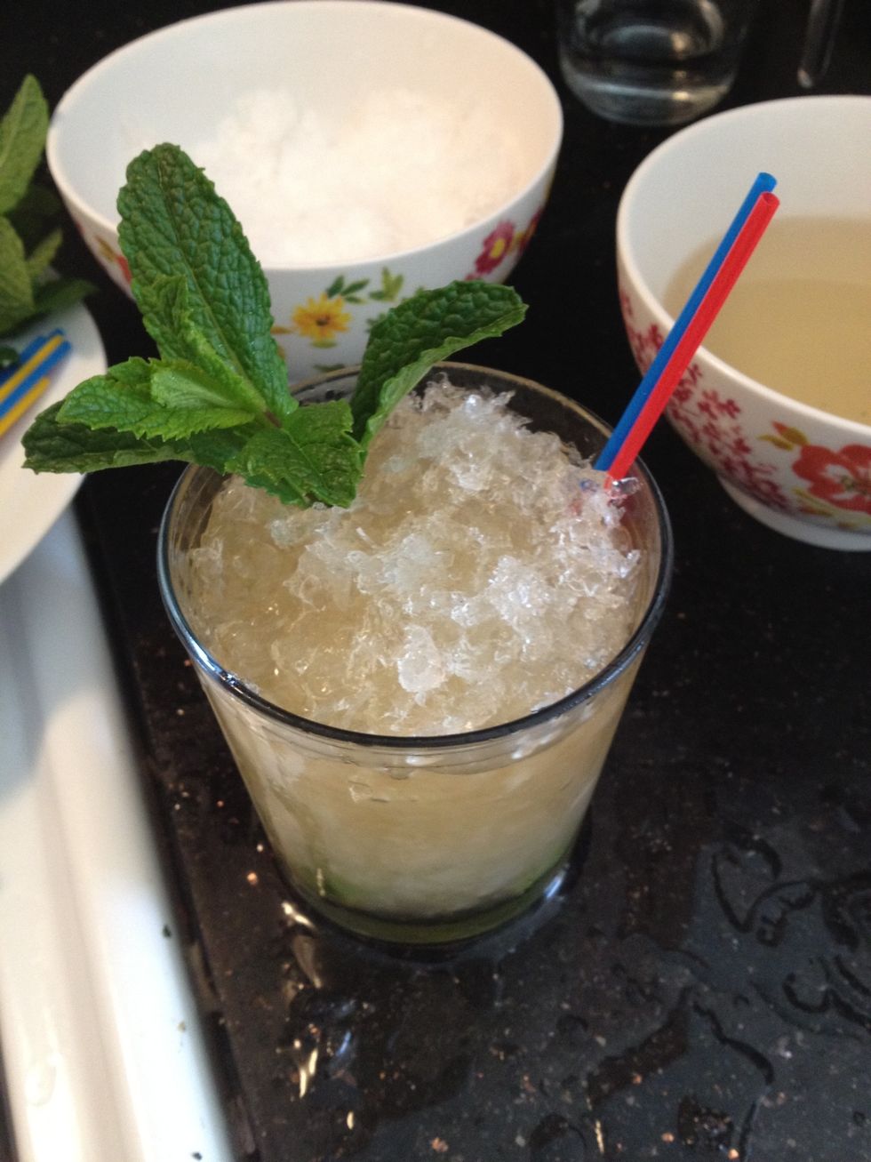 Cap glass with more crushed ice. Add a sprig of mint as a garnish.