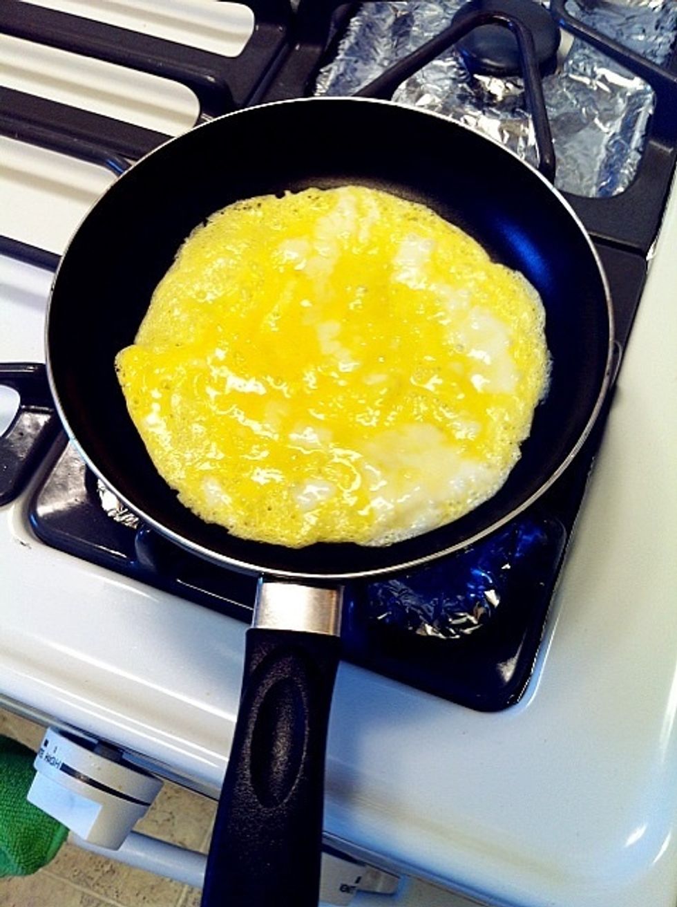 Carefully add the eggs to the centre of the pan, titling the pan so that the eggs spread out evenly over the bottom. Cook until the eggs have set on the bottom.
