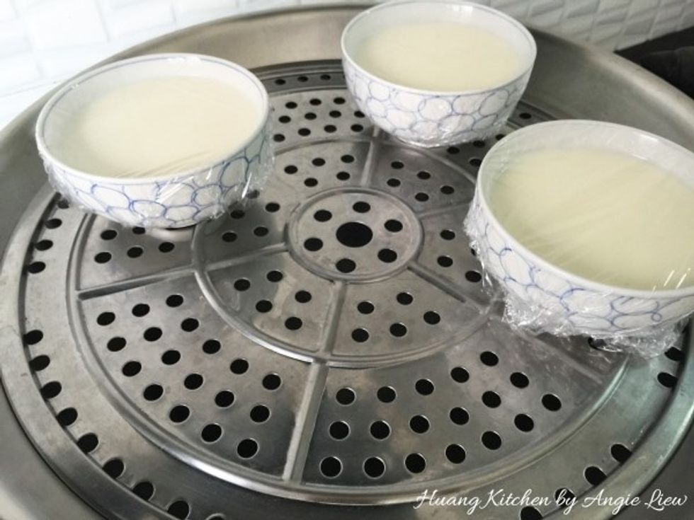 Carefully and gently place the wrapped bowls into the steamer over the boiling water.