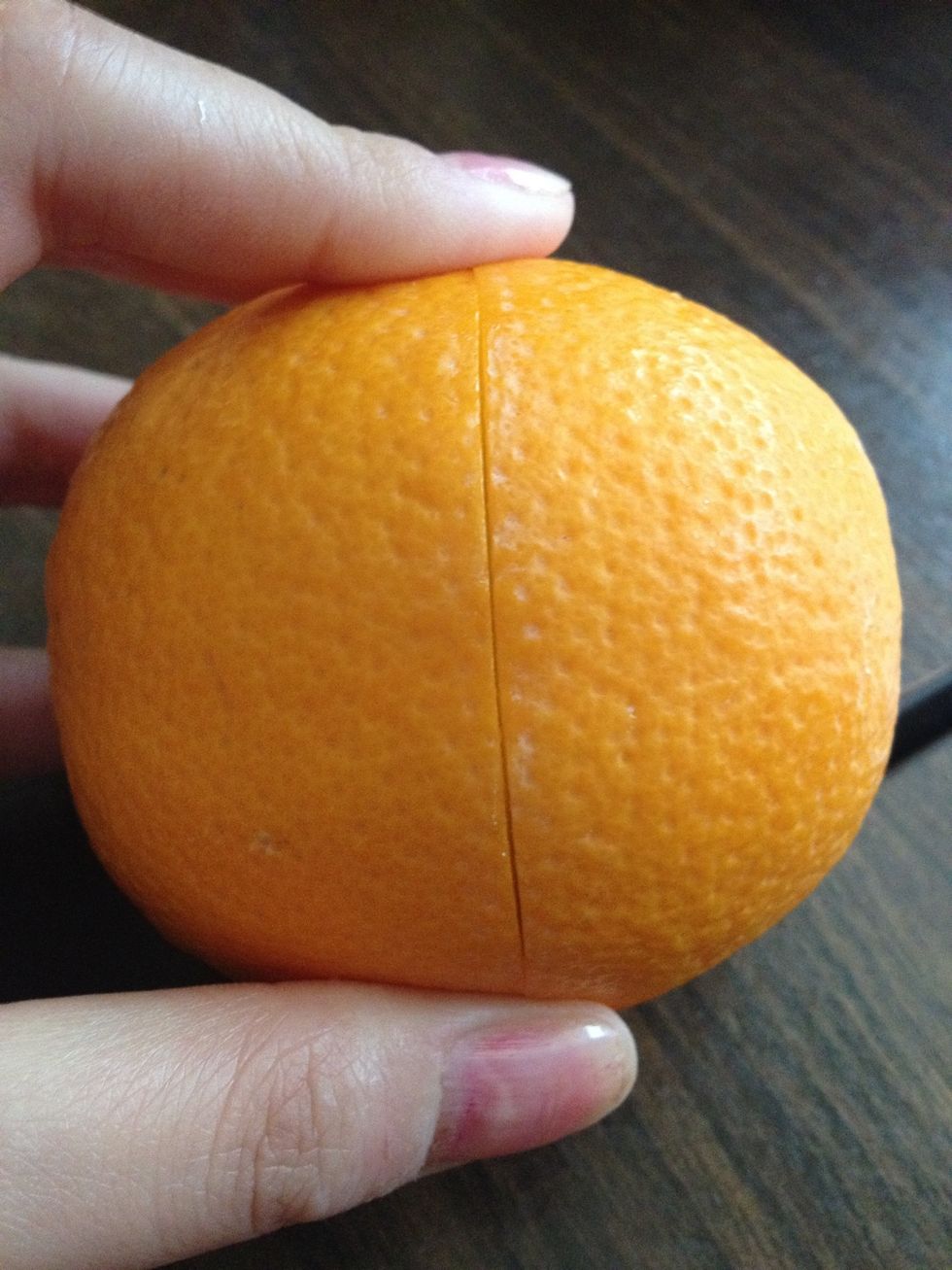 Carefully and lightly cut around the orange.