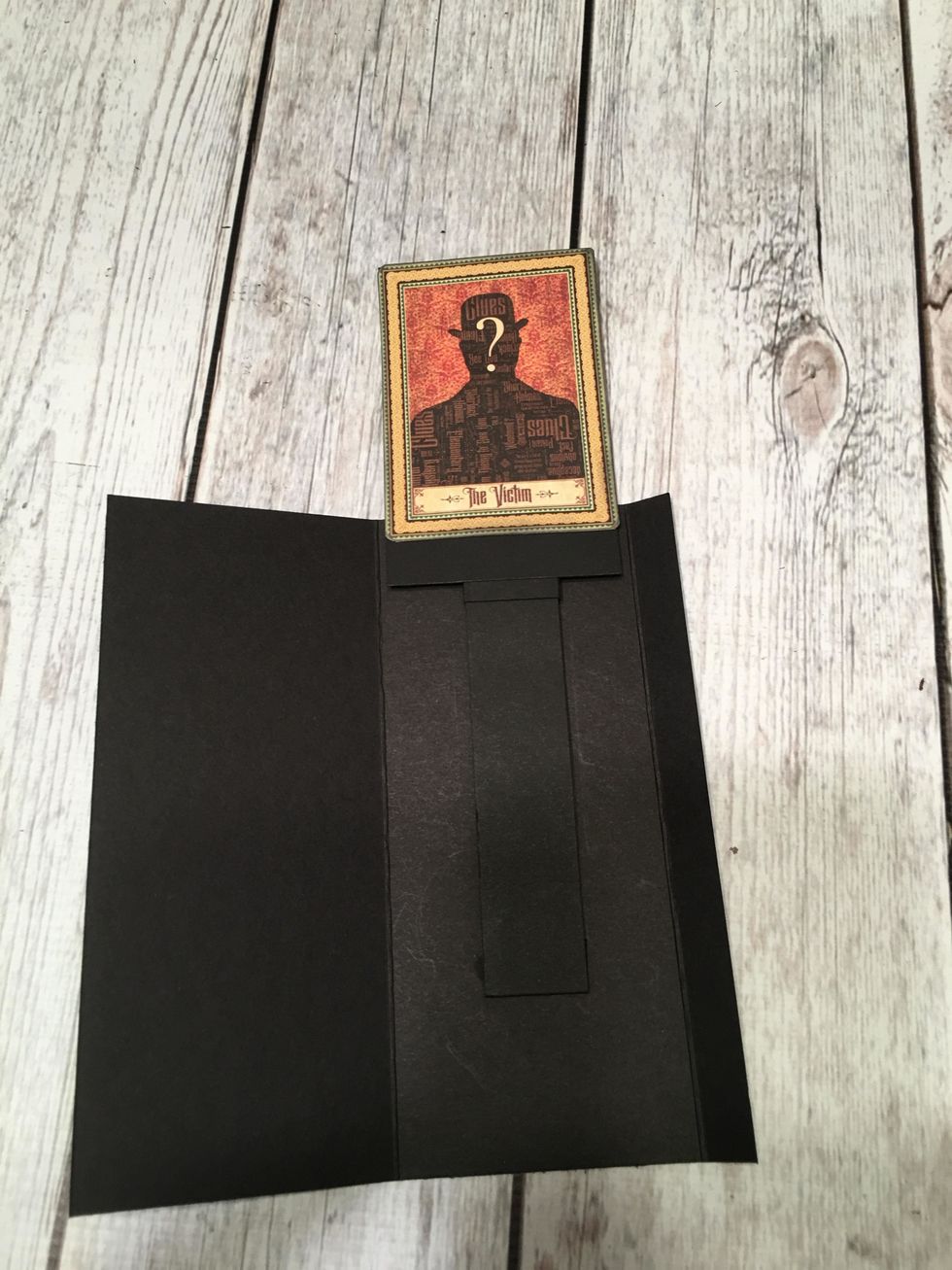 Carefully attach the bottom of the image card (already glued to card stock) to the slider piece.