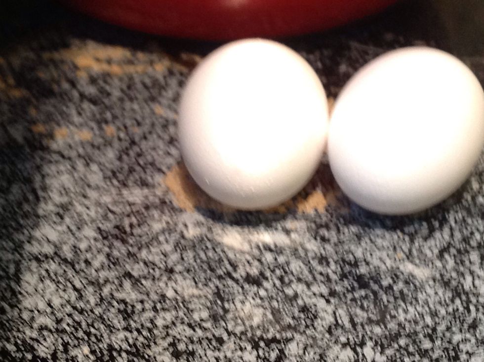Carefully crack 2 large eggs.