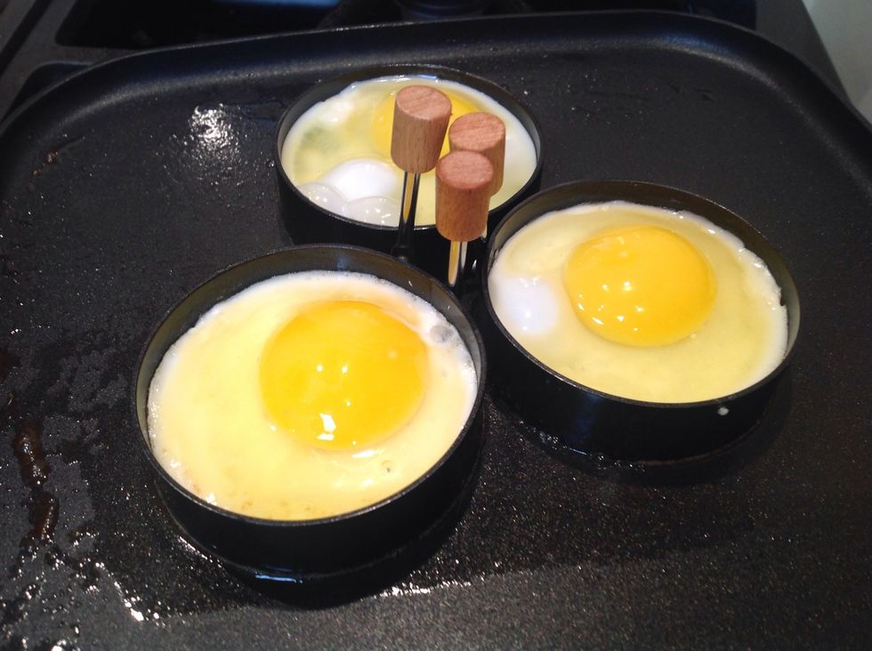 Carefully crack your eggs onto the nonstick fry pan. Optional: use egg fry rings. This is entirely an aesthetic choice. If you use them your eggs will cook circular making plating look very clean.