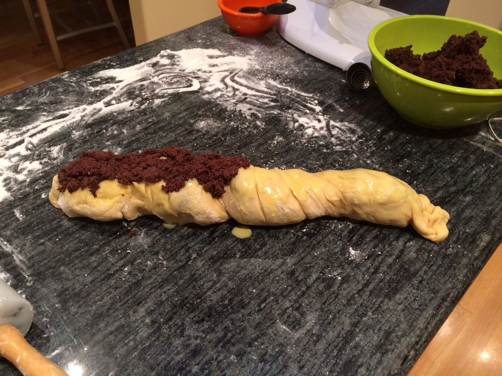 Carefully crumble 2 tablespoons filling over the left half of the roll, being careful not to let mixture slide off.