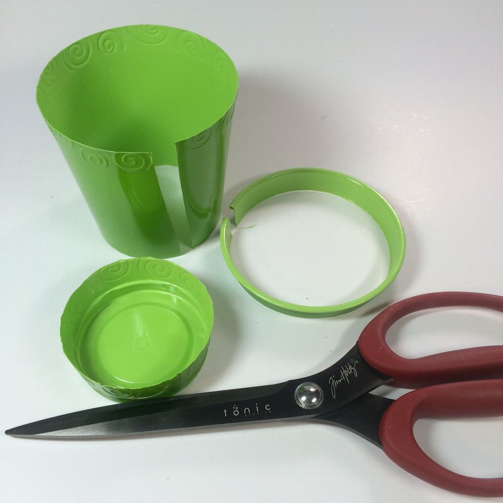 Carefully cut a slit down the side  of a 16 oz. plastic drink cup. Then cut off the top and bottom.