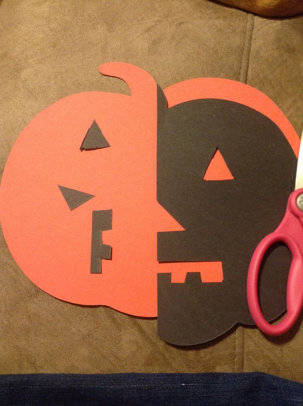 Carefully cut out the face shapes. To cut out the triangle eye, poke a small hole in one of the corners with your pencil. Then, slowly cut down the sides.