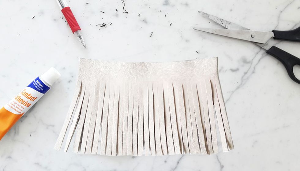 Carefully cut thin strips all the way to the end of the piece, making sure all the strips are equally 0.5cm wide. Be sure to stop at the 2cm border line each time.