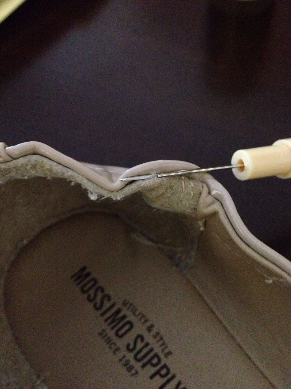 Carefully find the top seam, and ease the seam ripper between the inner and outer shoe. Carefully pop a few stitches (about an inch).