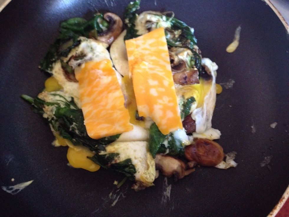 Carefully flip eggs over to cook other side. Then place cheese of choice on top