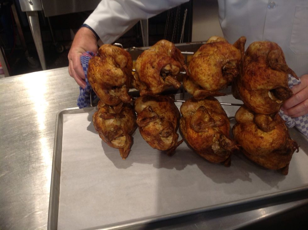 Carefully invert Blodgett Rotisserie Rack to allow roasted chicken to release
