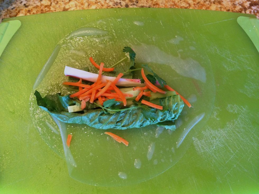 Carefully lay the paper on a flat surface and load the ingredients as shown, more toward the bottom of the paper.