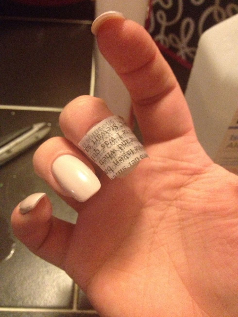 Carefully lay the piece of newspaper over your nail. Press and hold a rag or cloth over your nail and gently press for about 10 seconds.