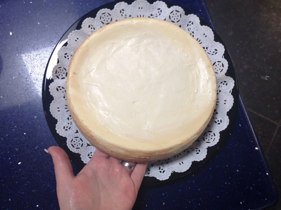 Carefully little with the cake over the doily and make sure it is centered.