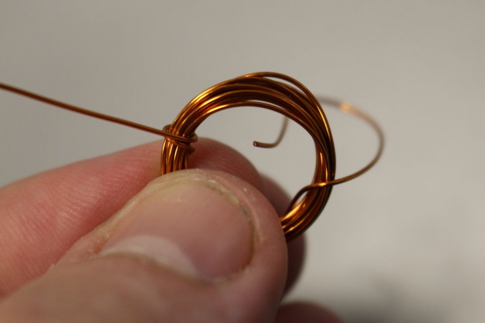 Carefully look at the coil and wrap the other loose end on the exact opposite side of the coil. They need to be centered opposite from each other so they balance each other.