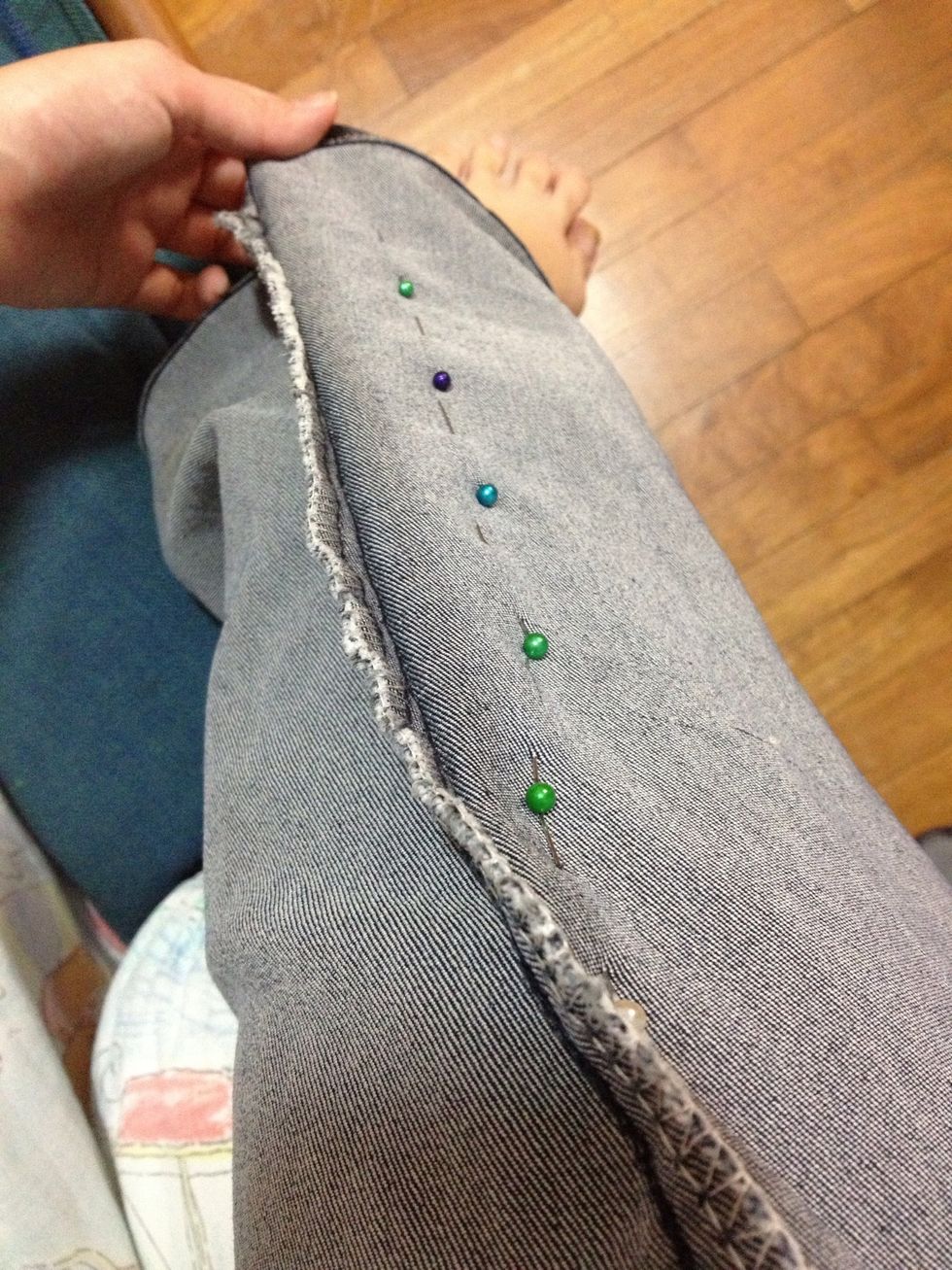 Carefully pin along the outside hem of your jeans, ie. the left hem of your left leg, and the right hem of your right leg.