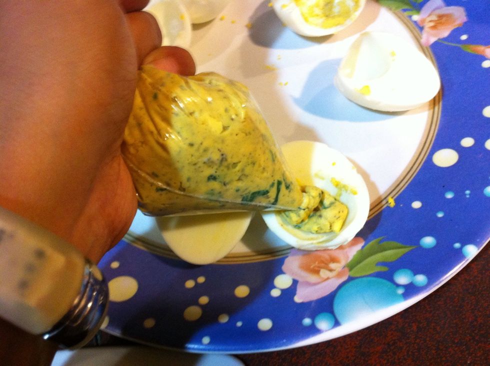 Carefully pipe the herbed egg mixture back into the egg white shells. You may want to take a clean wet towel and clean the egg whites first... Which I failed to do.