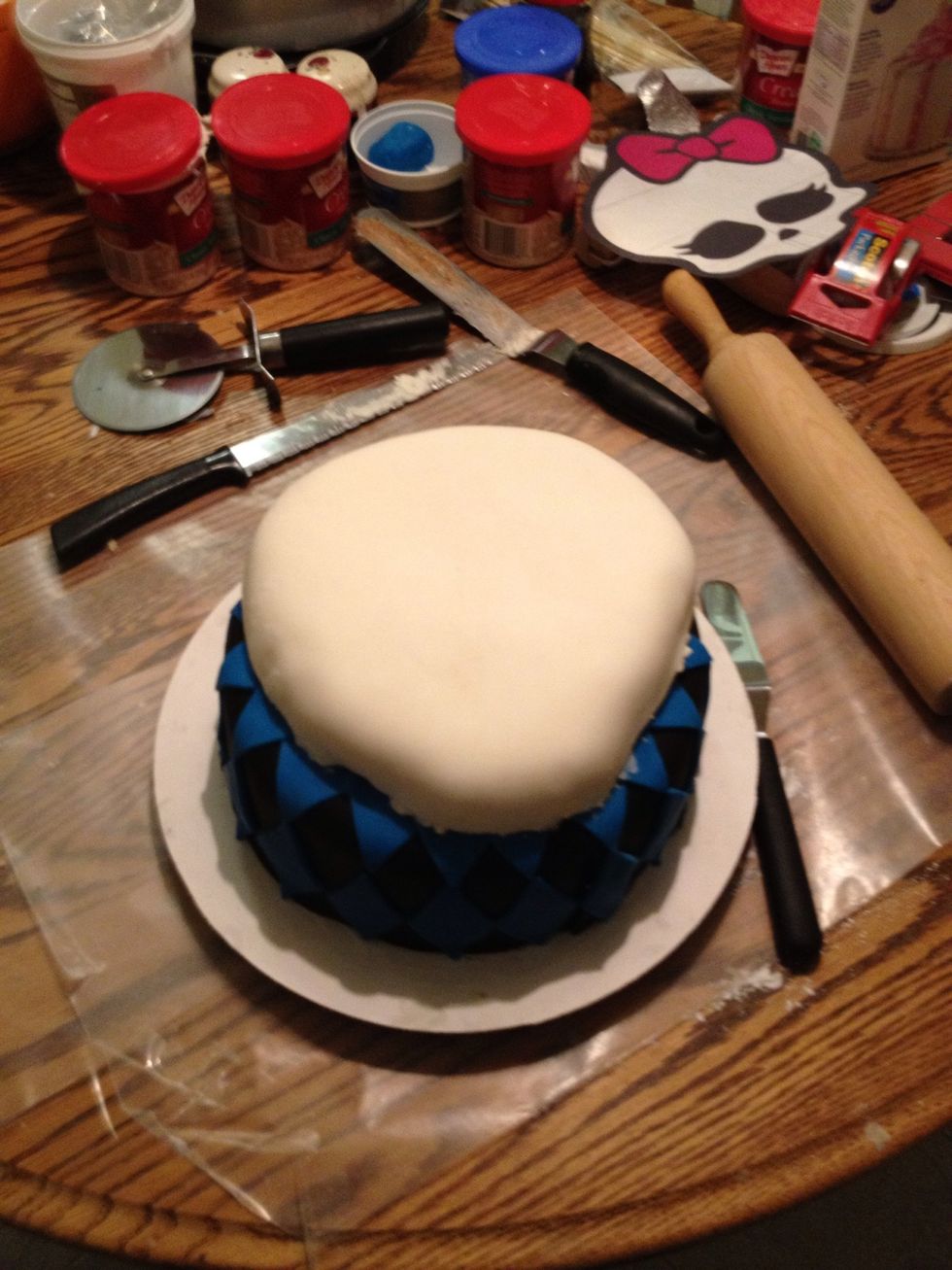 Carefully place the Skullete layer on top of the black and blue layer.